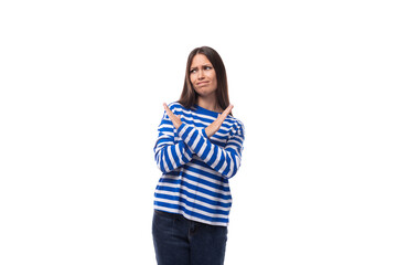 pretty young slim european model woman dressed in a blue sweater on a white background