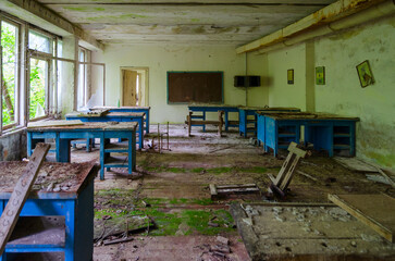 Fototapeta na wymiar Devastation in premises of abandoned school in resettled village of Pogonnoye in exclusion zone of Chernobyl, Belarus