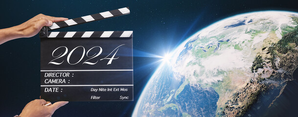 The year 2024, Hand-holding clapperboard or movie slate in video production and film industry.Storytelling of sci-fi, science and technology, global, and universe concepts. element of images furnished - obrazy, fototapety, plakaty