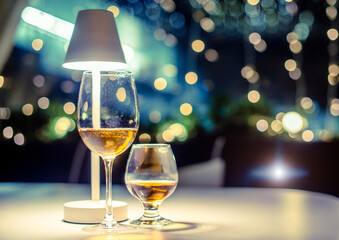 Glasses of white wine and cognac are on the table in the restaurant