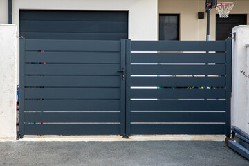 modern steel grey large gate double door aluminum portal with blades suburbs house street