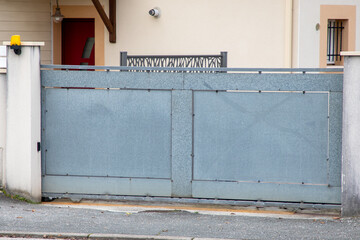 grey door panel brut steel house portal raw gray metal gate of suburban street