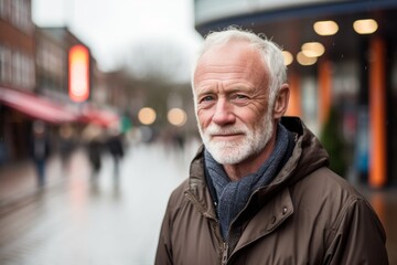 Portrait of a senior man with grey beard in the city.