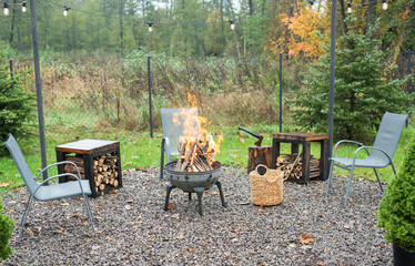 Fire pit and burning fire in a garden