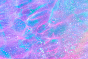 Beautiful neon purple, pink and blue transparent space alien glitter slime background texture....