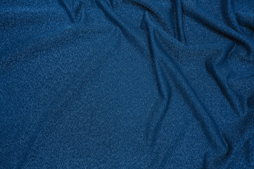 Trendy 80s, 90s, 2000s Background of draped dark blue fabric with silver lurex thread. Beautiful...