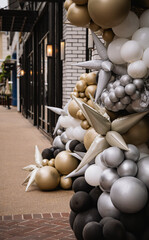 Outside Gold and Silver Balloon Display by Storefront