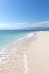 Fototapeta na wymiar Empty white sandy beach with clear waters, Gili Islands, Indonesia