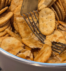 Smashing crackers in a bowl