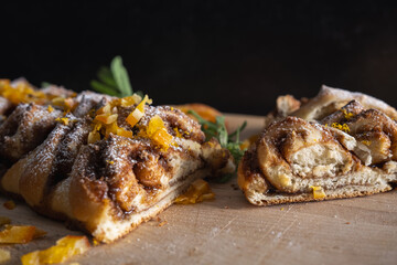 Sliced cardamom bread with candied oranges and powdered sugar.