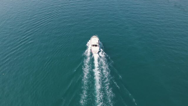 Tracking aerial shot following motor boat on a peaceful sunny summer day, Croatia