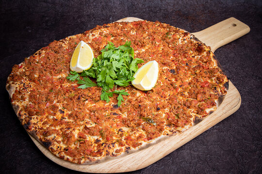 Lahm bi ajeen pizza bread served in wooden board isolated on background top view of Arabic Manaqeesh