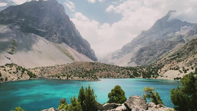 The Alaudin (Chapdara) lakes, lying at an altitude of 2800 m, are considered one of the most beautiful lakes of the Fan Mountains. Turquoise mountain lake. Pamiro-Alai. Tajikistan, Pamir 4K