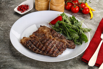 Grilled chuck roll steak with arugula