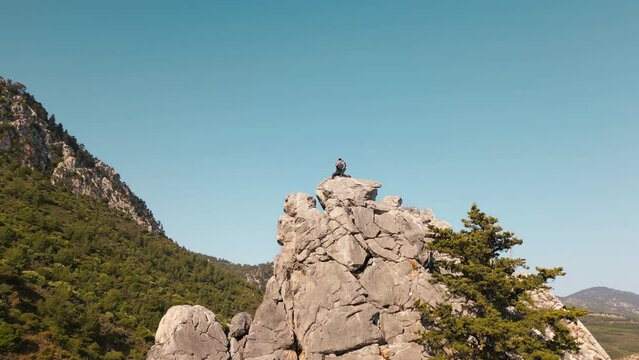 Tourist taking photos on a mountain peak