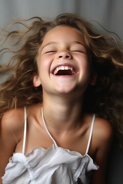 The innocent model in a candid, carefree moment, their laughter filling the air. The high-definition camera captures the joy and innocence in their expression, creating a truly heartening image.