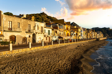 Fototapeta premium morning sunrise landscape on a city emnarkment with beach and sea coast and beautiful mediterranean street with buildings