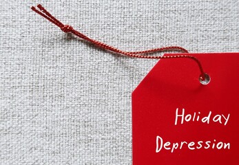 Red tag on copy space background written Holiday Depression-  means sadness in festive time,...