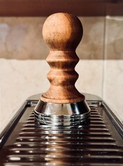 Close-up shot of a coffee machine and tamper