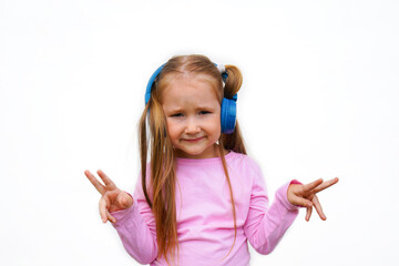 Carefree attractive girl with dark long hairstyle, listening music in headphones standing over white background