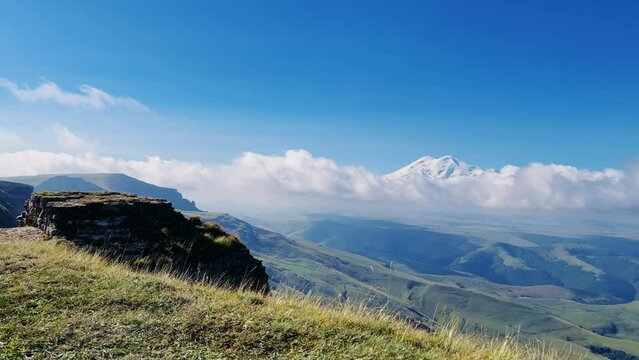 View of Elbrus and the ancient Amphitheater from the Bermamyt plateau. Caucasus 2023. A trip to Bermamyt, the Grand Canyon in Russia. Mountain landscape on a summer day. Karachay-Cherkessia. 4К