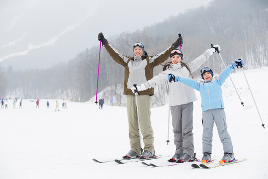 Young family skiing in ski resort