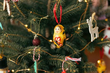 Set of ornaments hanging off a traditional Christmas tree.