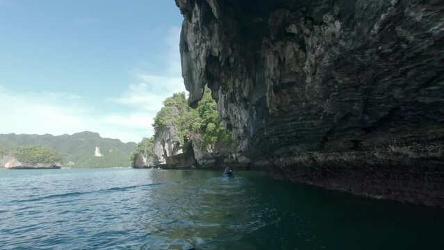 Riding underneath overhanging limestone cliff that has been eroded by wind and sea. Action camera POV shots.