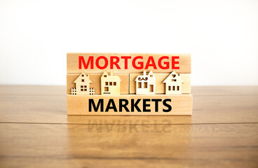 Mortgage markets symbol. Concept words Mortgage markets on beautiful wooden blocks. Beautiful wooden table white background. House model. Business mortgage markets concept. Copy space.