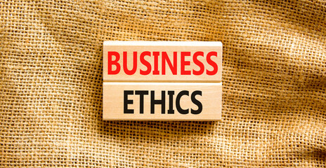 Business ethics symbol. Concept words Business ethics on beautiful wooden blocks. Beautiful canvas...