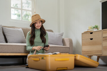Beauty asian traveler woman packing prepare stuff and outfit clothes in suitcase travel bag luggage...