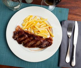 Portion of fried potatoes with beef tenderloin steak