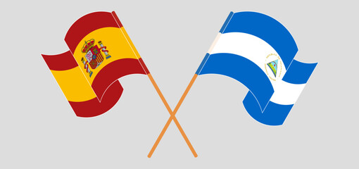 Crossed and waving flags of Spain and Nicaragua