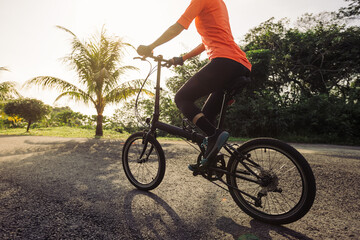 Fototapeta na wymiar Riding folding bike on tropical road