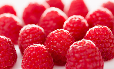 Handful of raspberry berries on white background