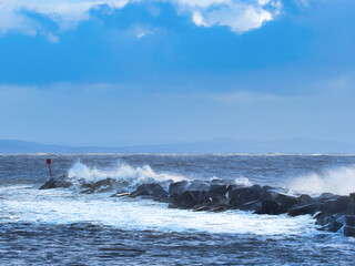 Stormy waves crashing over the Cobb seawall at Lyme Regis at the tail end of Storm Ciarán
