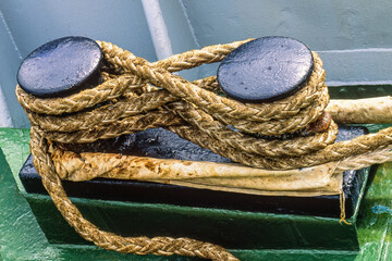 Fototapeta na wymiar Mooring hawser on a bollard on a ship