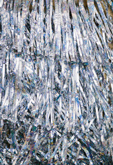 The texture of tinsel is silver. Decorations for Christmas and New Year.