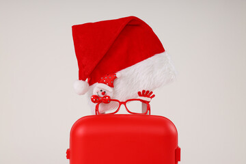 A red suitcase with a New Year's hat