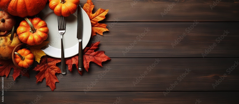 Poster top view of an autumn themed thanksgiving dinner table with decorated pumpkins and maple leaves copy