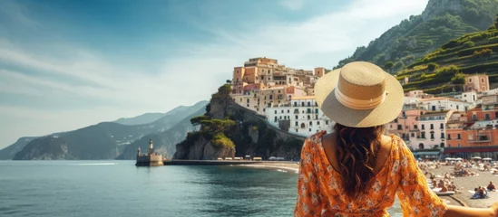 Foto auf Acrylglas Strand von Positano, Amalfiküste, Italien Tourist girl admires stunning Amalfi Coast in Italy copy space image