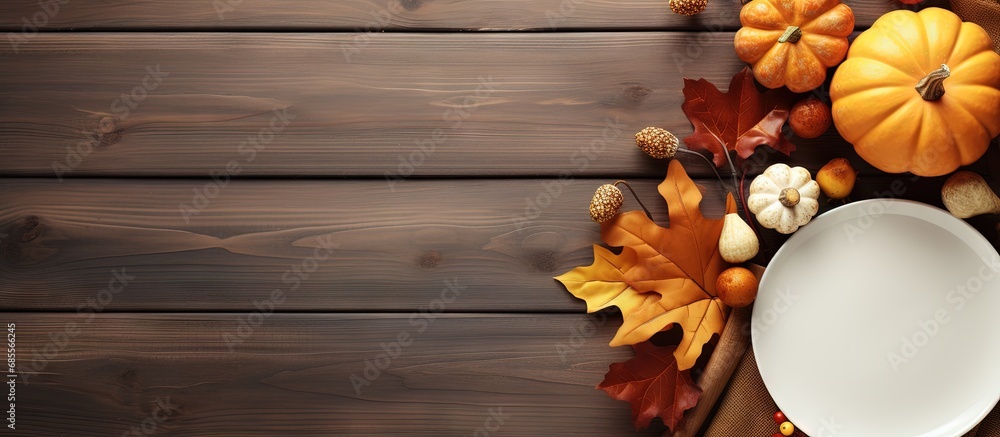 Poster top view of an autumn themed thanksgiving dinner table with decorated pumpkins and maple leaves copy
