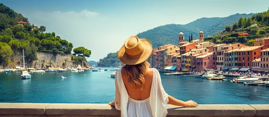 Photo sur Plexiglas Europe méditerranéenne Tourist girl enjoying view of picturesque village in Portofino Italy copy space image