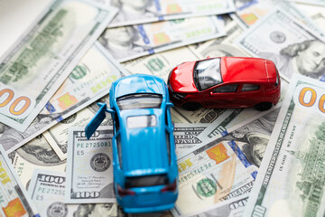 concept of car insurance, imitation collision, amid American banknotes, car accident