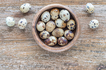 Quail eggs on wooden background.