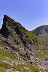 High and rocky mountains in the summer season. Landscape with the wild Carpathians of Romania