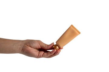 Plastic tube for cream or lotion in hand. Skin care or sunscreen cosmetic on transparent background.