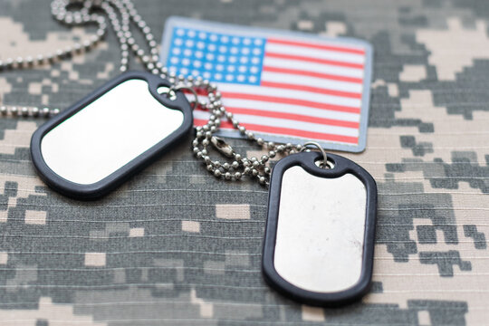Military cap, tag and chevrons of USA army on green background, closeup - Powered by Adobe
