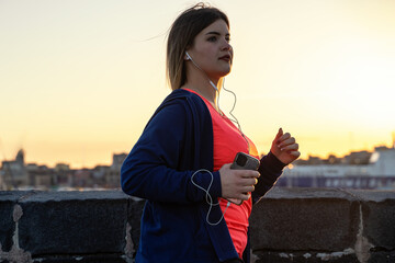 A confident, full-figured woman engages in her evening run, empowered by the city's twilight glow, celebrating body positivity and the joy of movement.