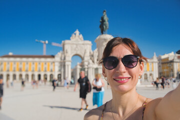 Happy tourist visiting Lisbon, Portugal - Beautiful young woman taking selfie while travel in...